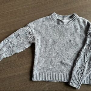 Pale blue sweater with openwork sleeves